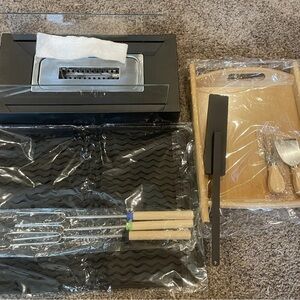 portable tabletop fire pit with multiple attachments. opened to confirm contents